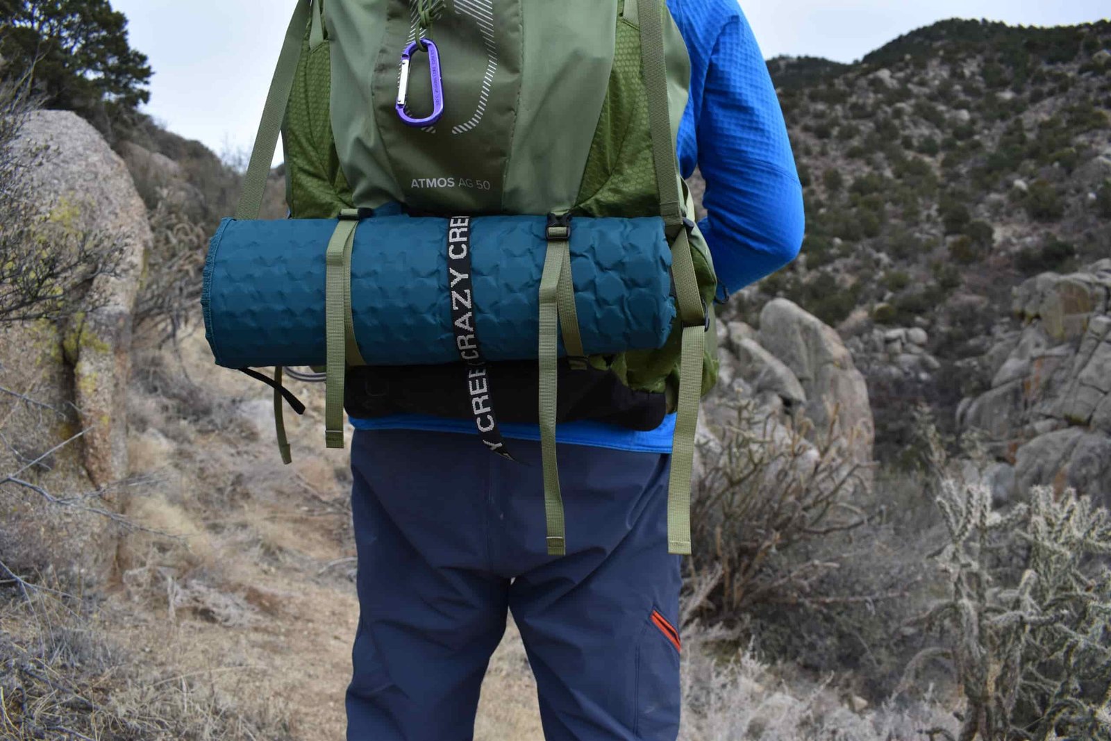 Close up of the Hex 2.0 rolled up and strapped to the bottom of a 50 L backpack