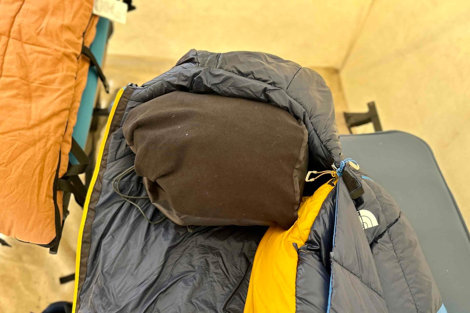 Close-up image of a stuff-sack pillow tucked inside the hood of a sleeping bag.