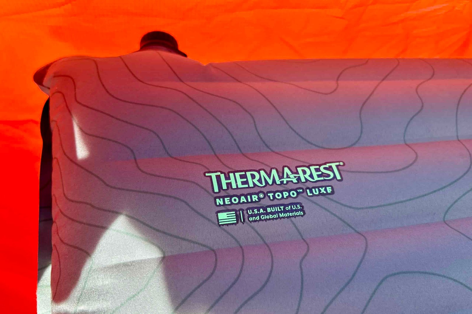 Close-up image of the logo of a camping mattress printed in the corner.