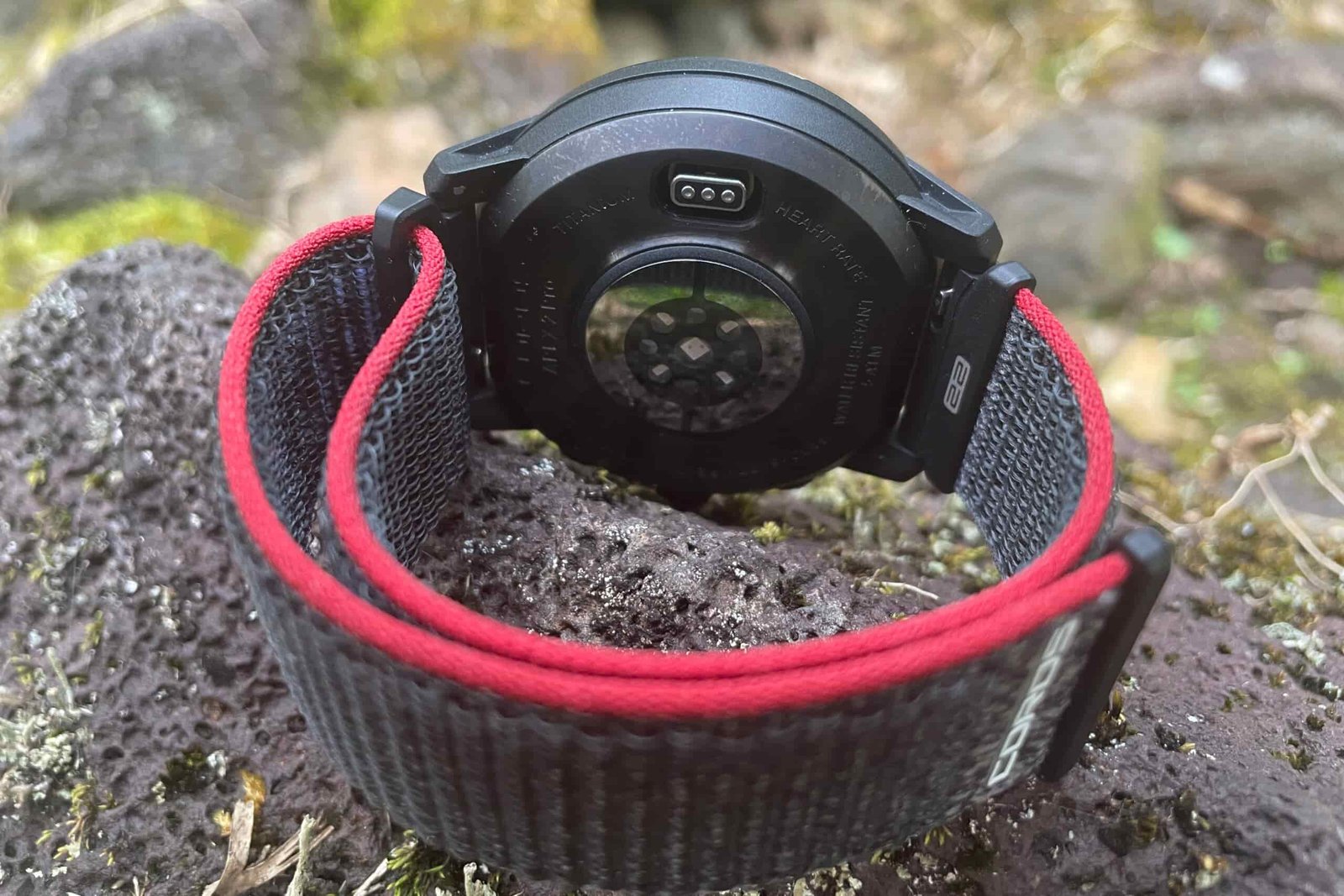 A closeup of the underside of a GPS watch.