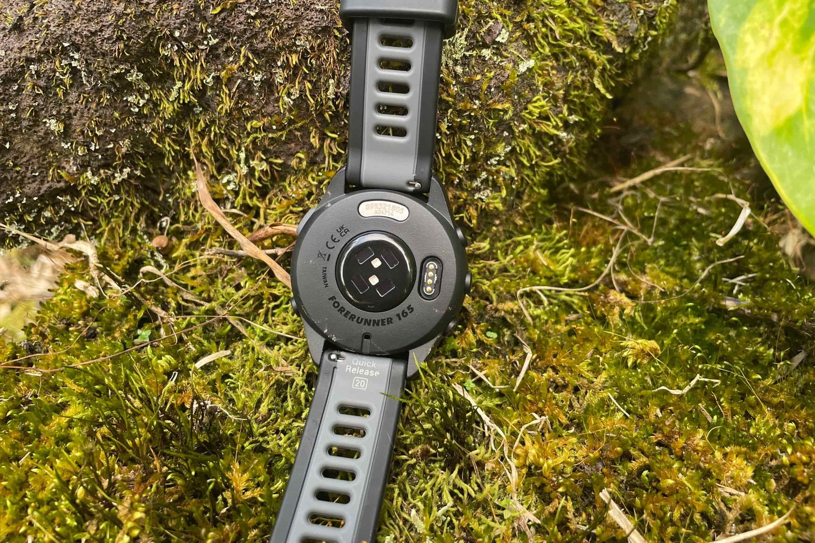 A closeup of the underside of a GPS watch.