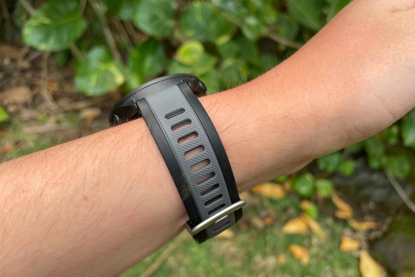 A closeup of the band of a GPS watch being worn on the wrist.