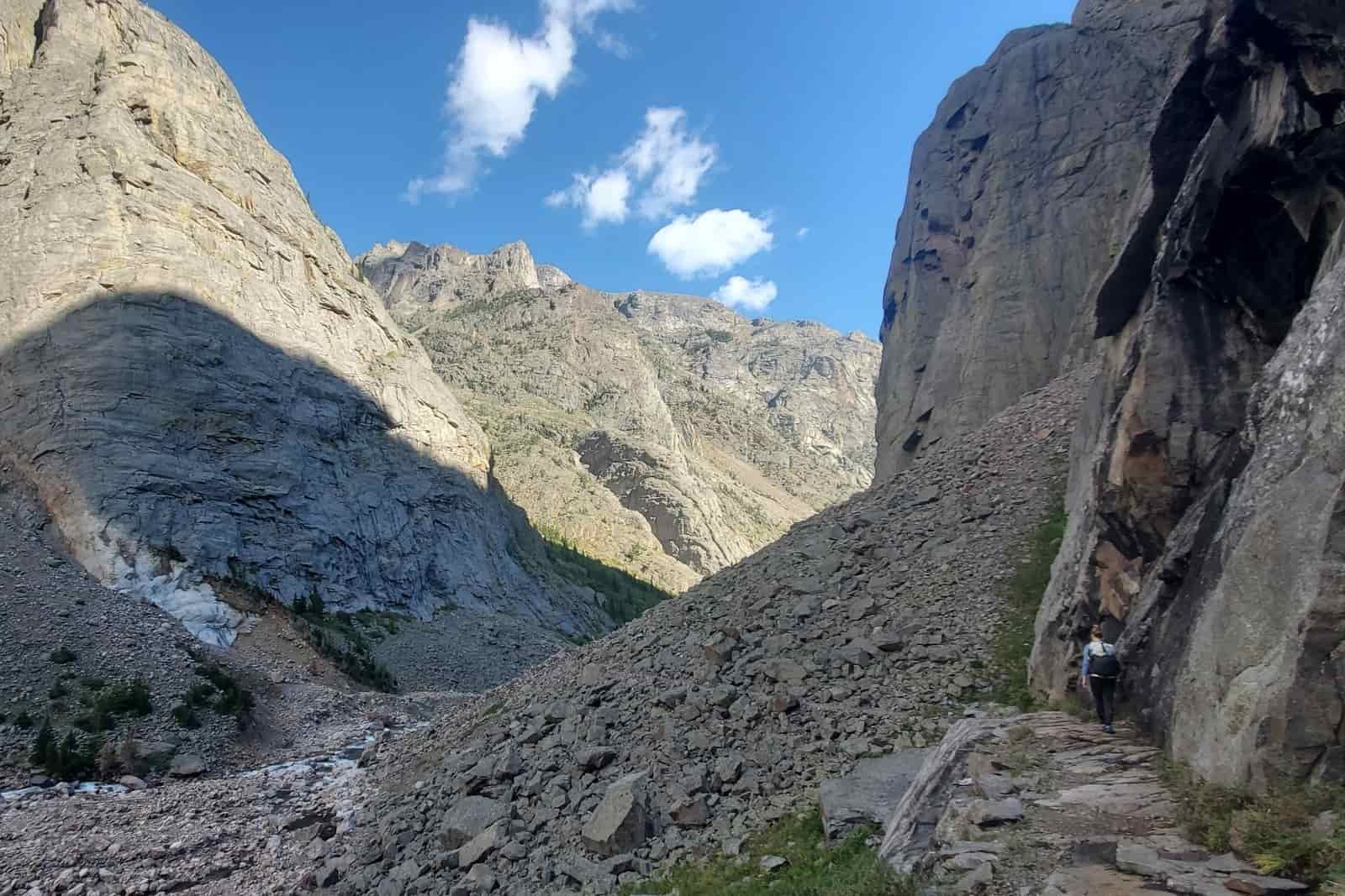 A trail descends through a deep canyon.