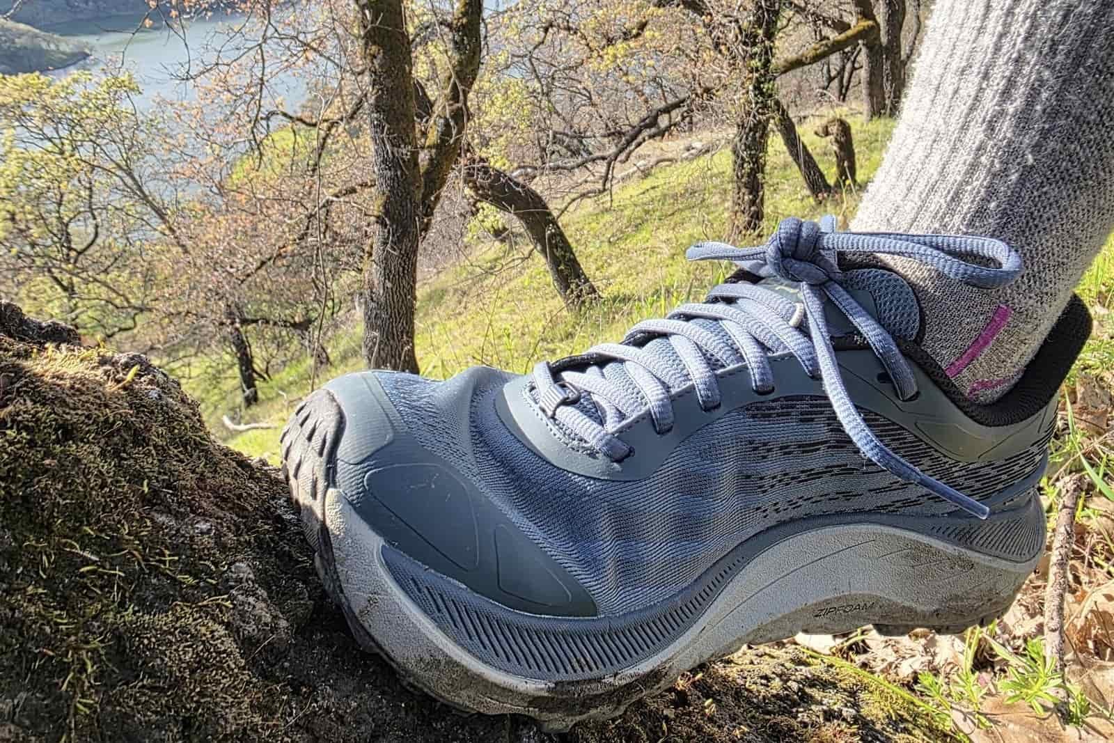 Close-up showing how the upper material of a hiking shoe bunches up due to its high volume and roomy fit.