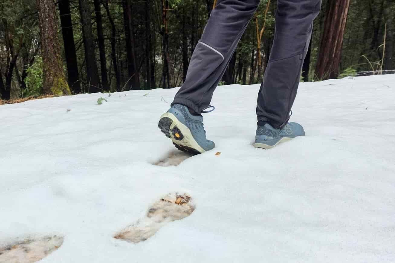 Person walking in snow wearing the newest version of the Topo Ultraventures.