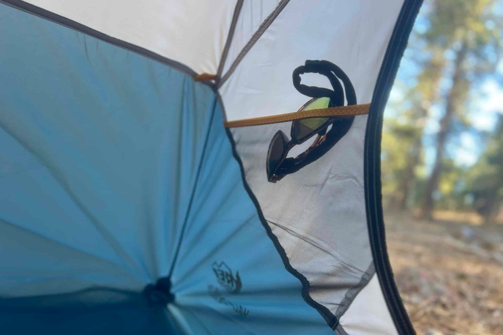 sunglasses in a tent's interior side pocket