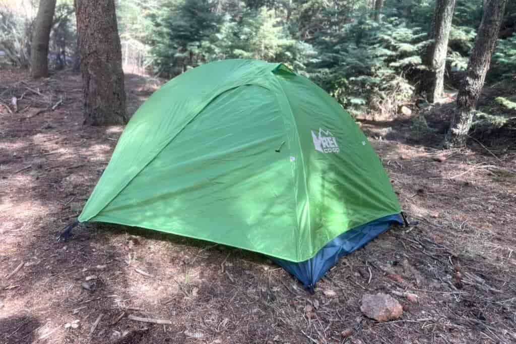 a green tent in a forest