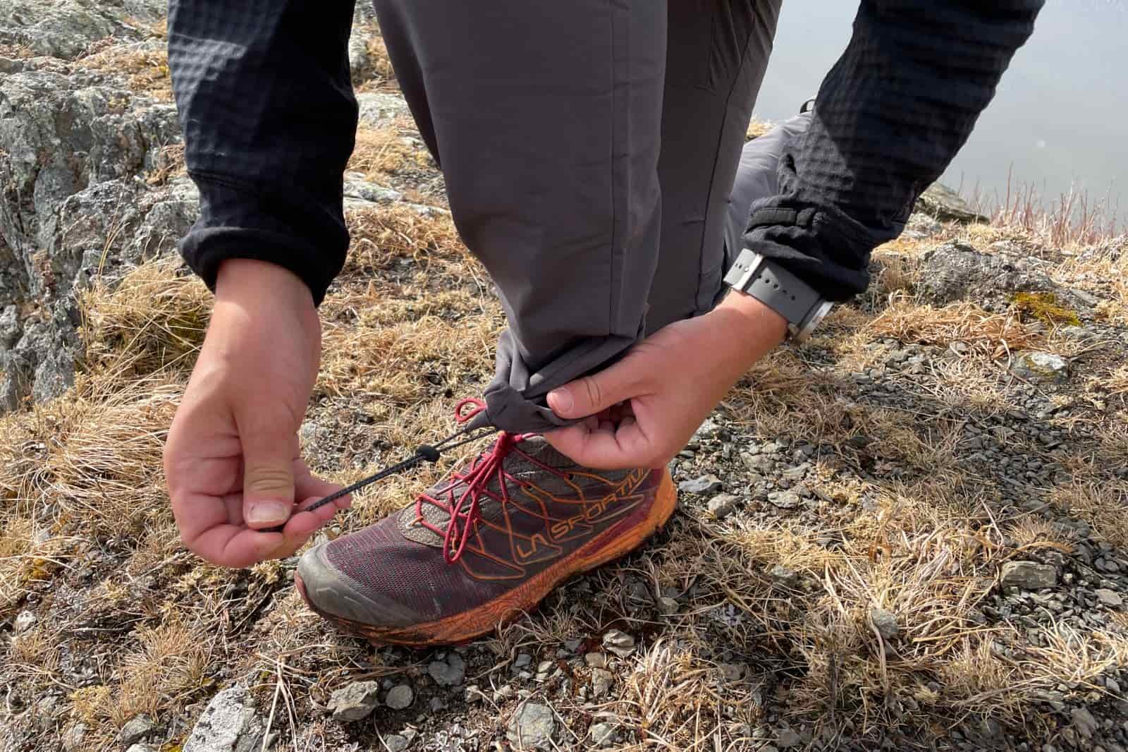 A closeup of the ankles on pants being cinched.
