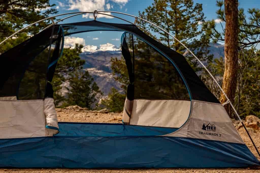 a tent is setup with no fly, doors open, and a mountain view