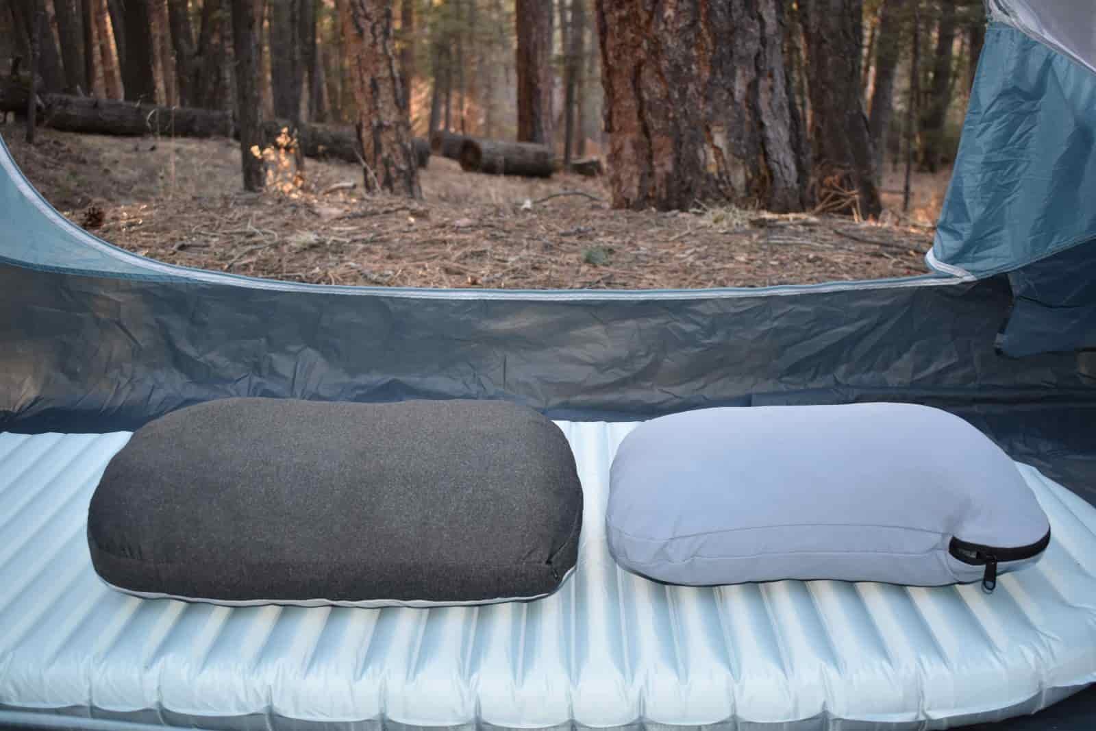 2 camping pillows on an air mattress inside a tent at a campground