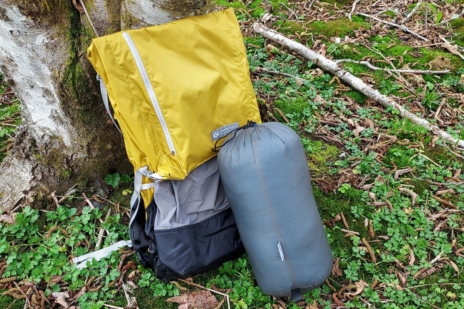 Katabatic Flex 22 Quilt packed down with a standard ultralight 50L backpack for scale