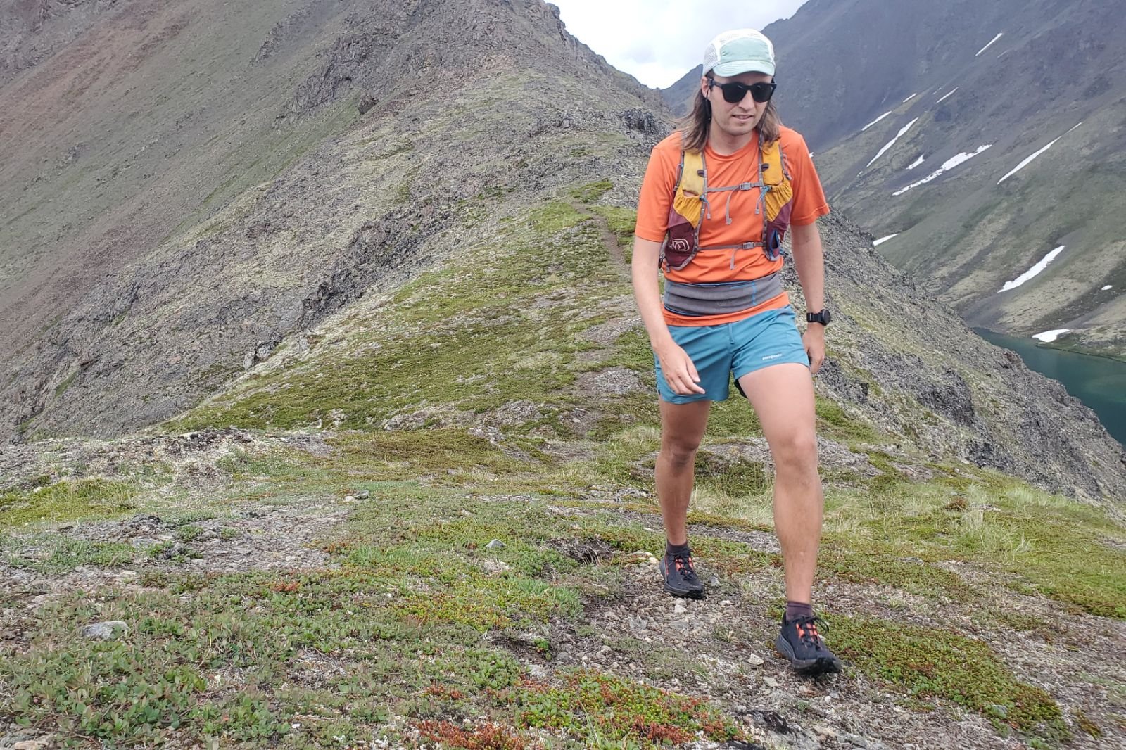 A man hikes on an alpine trail