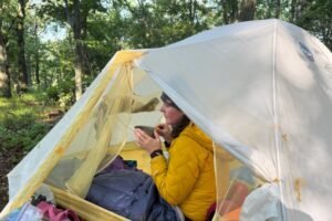 Hiker drinking coffee in the Hyperlite Mountain Gear 20 in camp on the Appalachian Trail