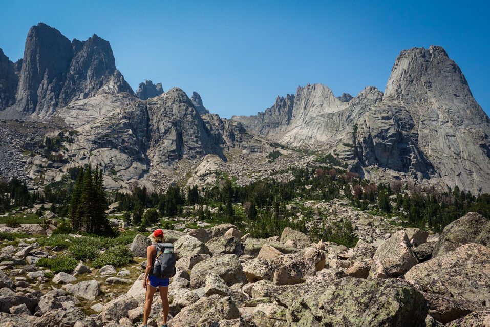 a backpacker looking at the cirque of the towers