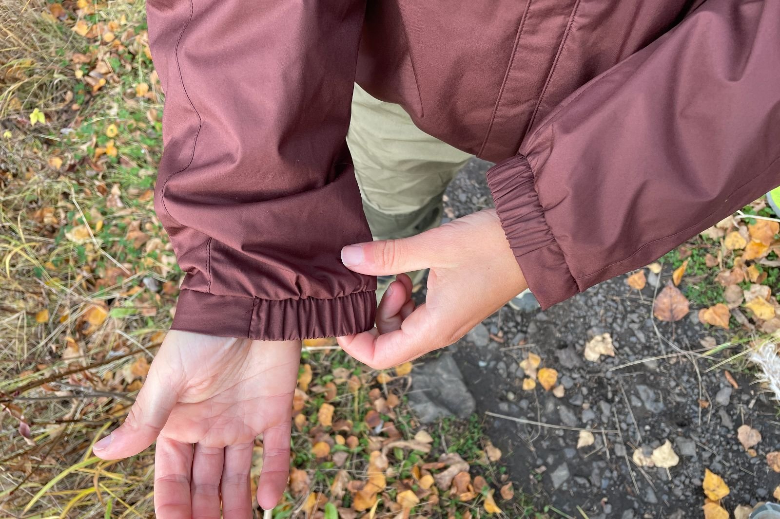 A closeup of the elastic cuffs of a marron jacket.