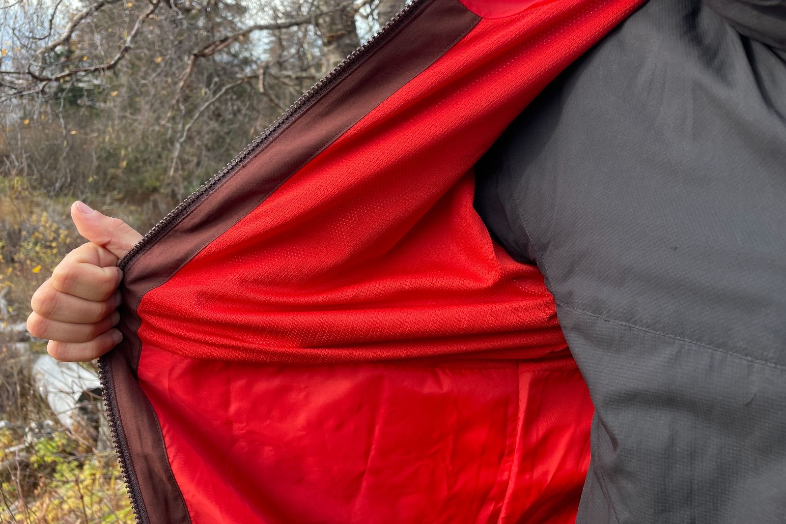 A closeup of the interior of a red jacket showing the different materials.