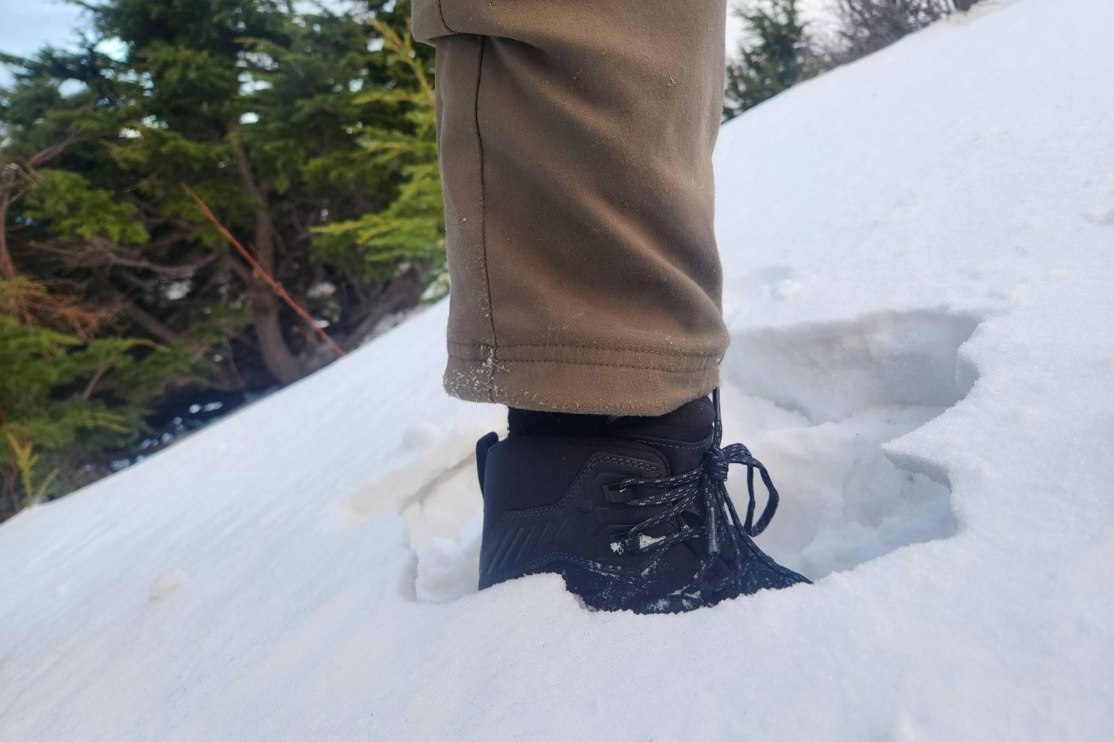 A pair of winter boots submerged in snow.