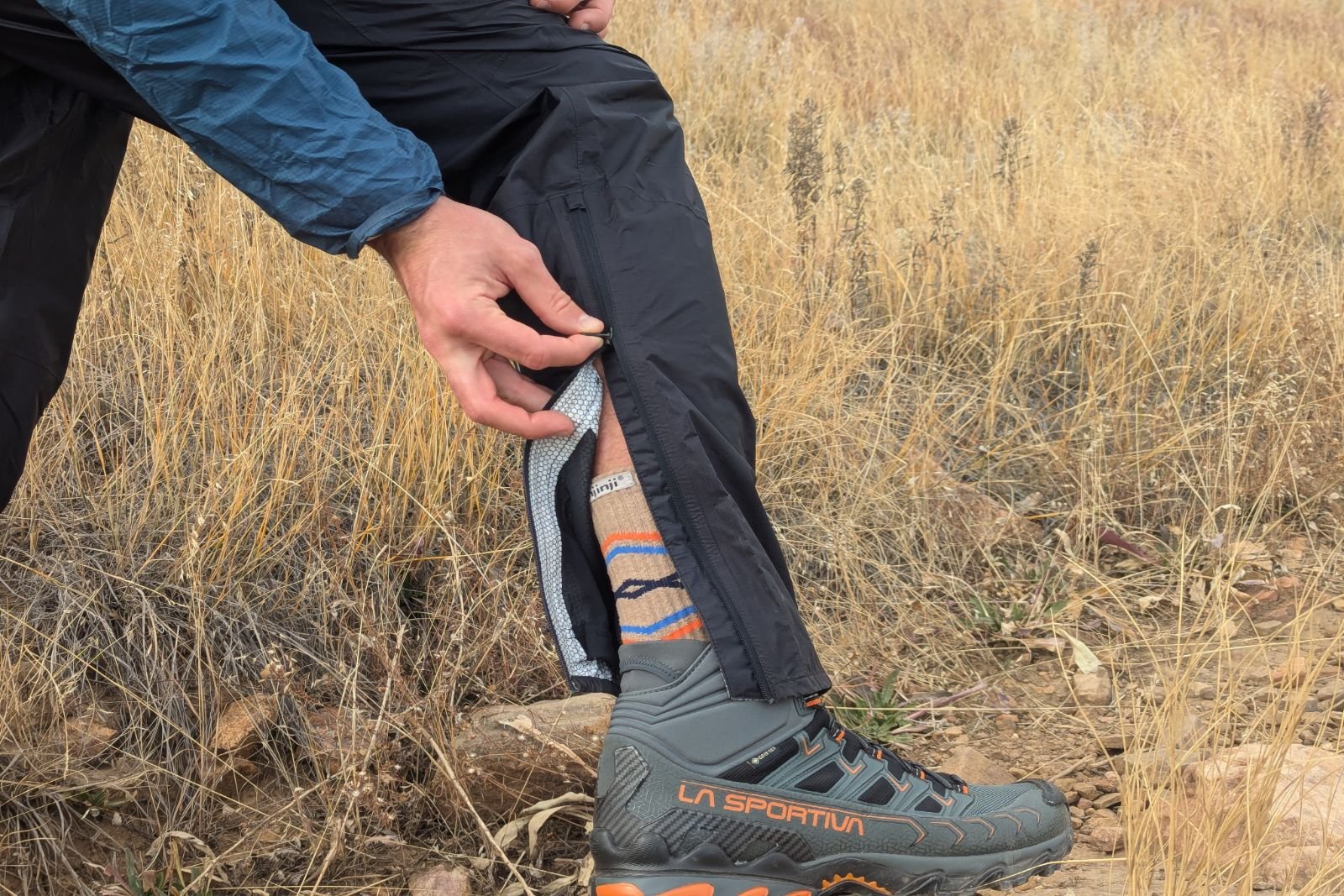 Demonstrating the ankle zipper on the Salomon Bonatti rain pants.